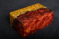 epoxy resin gold with nature burl BURMA PADAUK wood cube on black background Royalty Free Stock Photo