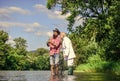 Casting that fish off. retired father and mature son with beard. Fly fishing adventures. friends men with fishing rod Royalty Free Stock Photo