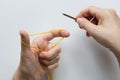 Casting on. Knitting. Position of fingers and thread for stitches on white background. Top view Royalty Free Stock Photo