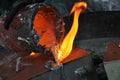 Casting liquid aluminium from crucible into sand form