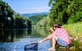 Casting off. mature bearded man with fish on rod. successful fisherman in lake. hipster fishing with spoon-bait. fly