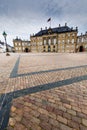 Castle Amalienborg with statue of Frederick V in Copenhagen, Denmark. The castle is the winter home of the Danish royal family Royalty Free Stock Photo