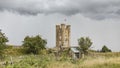 Castle and broken shed against a stormy sky