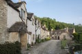 Street view of old riverside cottages in the picturesque Castle Combe Village, Cotswolds, Wiltshire, England - UK Royalty Free Stock Photo