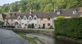 Street view of old riverside cottages in the picturesque Castle Combe Village, Cotswolds, Wiltshire, England - UK Royalty Free Stock Photo