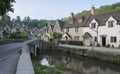 Street view of old riverside cottages in the picturesque Castle Combe Village, Cotswolds, Wiltshire, England - UK Royalty Free Stock Photo