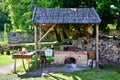 Castle courtyard, herbalist shop`s bench stands under a wooden canopy