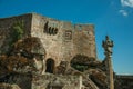 Castle facade with open gateway on stone wall