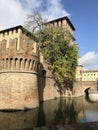 Castle in Fontanellato, Parma, Italy. Medieval castle with moat across trees and blue sky. Water reflections Royalty Free Stock Photo