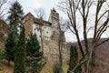 Castle is on a hill with trees in the background. December 16, 2024 Bran Romania Royalty Free Stock Photo