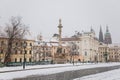 Castle from Hradcany Square, spiers of st Vitus cathedral, archbishop`s palace and Marian Plague Column, snow in winter day,
