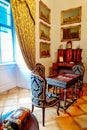 Castle interior. Antique carved furniture, table and chairs. Paintings on the walls. Renaissance castle Horsovsky Tyn, Czech