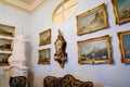 Castle interior. Antique clock and paintings in carved frames on the wall. Renaissance castle Horsovsky Tyn, Czech Republic
