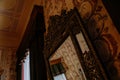 Castle interior. Antique mirror in a carved frame. Castle Duchcov, Czech Republic