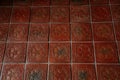 Castle interior. Brick clay floor. Ceramic floor tiles with a picture of a rose. Medieval castle Rozmberk nad Vltavou, South
