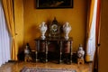 Castle interior. Chest of drawers with brass inlay, Chinese porcelain vases and antique clock. Milotice castle, South Moravia,