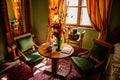 Castle interior. Men`s bedroom, green soft armchairs and a coffee table with an open book and two cups. Jezeri, Northern Bohemia,