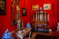 Castle interior. Men`s salon, used as a smoking room for gentlemen. Red room with wooden antique secretary. Castle Duchcov, Czech