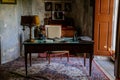 Castle interior. An office with a desk and an armchair. Antique lamp and telephone. Pictures and photos on the walls.  Jezeri, Royalty Free Stock Photo