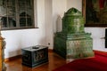 Castle interior, Retro style room with wood carved baroque and renaissance furniture, antique green ceramic tiled stove and large