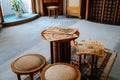 Castle interior, Secession art nouveau style, small round table, stools, old newspapers and magazines, blue carpet, renaissance