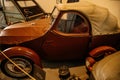 Castle interior, small retro car with tarpaulin on Jawa 250 engine, racing car exhibition, mannequins male racers, renaissance