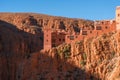 Castle kasbah hotel on the high Cliff in amazing place at Picturesque Serpentine mountain road in Gorges Dades in high Royalty Free Stock Photo