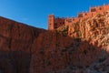 Castle kasbah hotel on the high Cliff in amazing place at Picturesque Serpentine mountain road in Gorges Dades in high Royalty Free Stock Photo