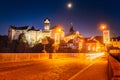 Castle Loket in winter, long night exposure with beautiful blue sky and yellow street christmas city lights with view on river Royalty Free Stock Photo