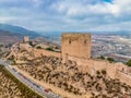 Aerial view of Lorca medieval castle with Tour de Alfonz, square towers , covering the entire long plateau of the hill Royalty Free Stock Photo