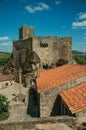 Castle and old houses encircling square with pillory Royalty Free Stock Photo