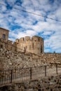 Castle Overlooking the Mountains: Breathtaking View of a Typical Italian Castle with Crenellations and Blue Sky in Rocca Imperiale Royalty Free Stock Photo