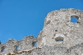 Battlement of medieval castle ruin against blue sky