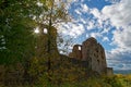 Sunstar in window of medieval castle ruin in autumnal landscape