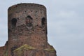 Castle ruins in KoÃâo. Destroyed towers and defensive walls made of red brick on the bank of the Warta River