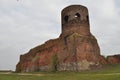 Castle ruins in KoÃâo. Destroyed towers and defensive walls made of red brick on the bank of the Warta River