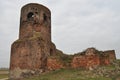 Castle ruins in KoÃâo. Destroyed towers and defensive walls made of red brick on the bank of the Warta River