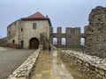 Castle ruins in Rabsztyn in Poland in rainy and foggy weather.