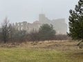 Castle ruins in Rabsztyn in Poland in rainy and foggy weather.