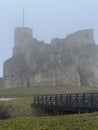 Castle ruins in Rabsztyn in Poland in rainy and foggy weather.