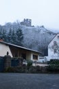 Castle ruins on snowy hill above houses Royalty Free Stock Photo