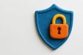 A castle and a shield made of plasticine as a symbol of cybersecurity. Space for text. Royalty Free Stock Photo