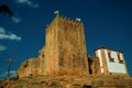 Castle and square tower over rocky hill with cross Royalty Free Stock Photo
