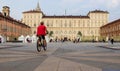 Castle Square in Turin with red woman in bicycle