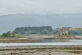 Castle Stalker in the middle of Loch Linnhe, with trees and mountains behind. Argyle and Bute, Scotland, UK. September 19, 2014. Royalty Free Stock Photo