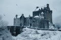 A castle surrounded by snow with a bridge in front of it, creating a picturesque winter scene, An ancient castle covered in snow Royalty Free Stock Photo