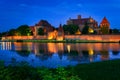 The Castle of the Teutonic Order in Malbork by the Nogat river at dusk. Poland Royalty Free Stock Photo