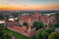 The Castle of the Teutonic Order in Malbork by the Nogat river at sunset. Poland