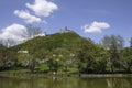 Castle on top of hill by river.