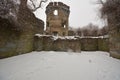 Remaining walls and tower of Bancroft Castle on top of a hills in a snow storm